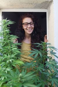 Portrait of woman watching her marijuana plants