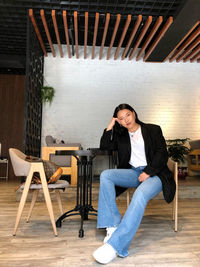 Portrait of woman sitting on chair