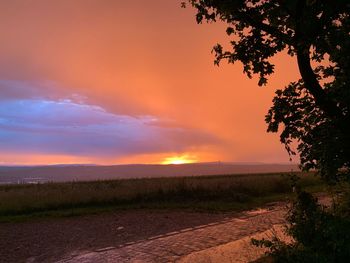 Scenic view of field against sky during sunset