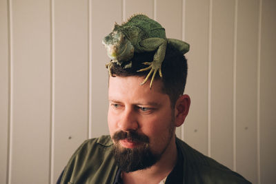 Man with iguana on head