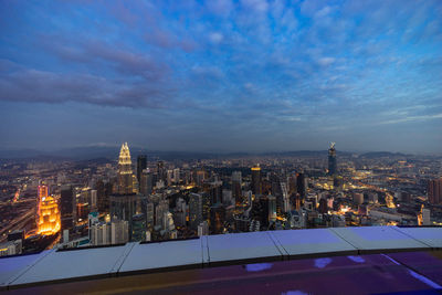 Illuminated cityscape against sky