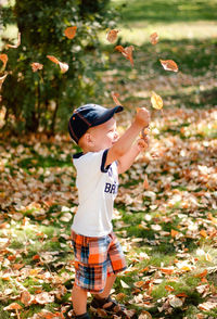 Full length of boy standing on field during autumn