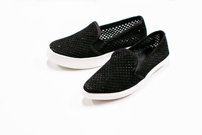 Close-up of shoes against white background