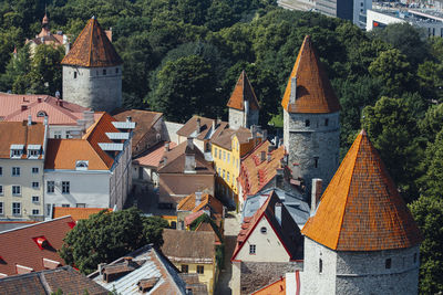 High angle view of houses amidst trees and buildings