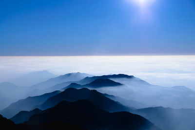 Scenic view of mountains against blue sky