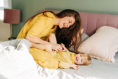 Portrait of young woman sleeping on bed at home