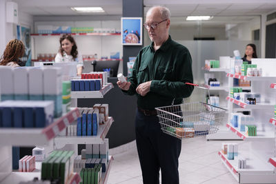 Portrait of young man standing in store