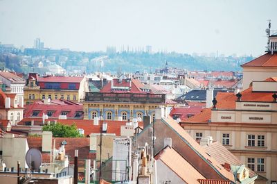 High angle view of houses in town against sky