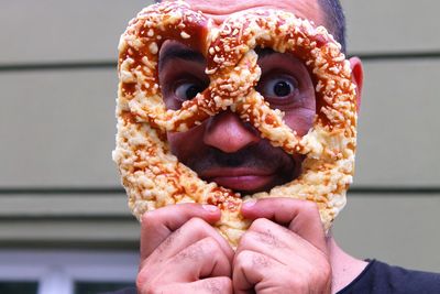 Close-up of man holding pretzel