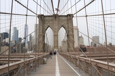People walking on footbridge in new york city 