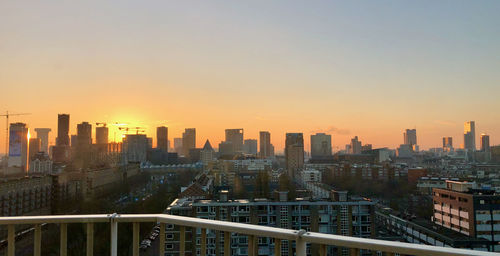 High angle view of buildings against sky during sunset