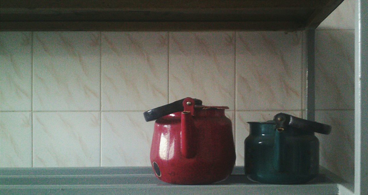 indoors, wall - building feature, red, still life, technology, wall, table, no people, home interior, close-up, absence, old-fashioned, metal, electricity, domestic room, single object, empty, equipment, connection, door