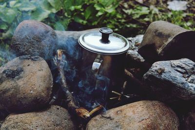 Close-up of old lamp on rock