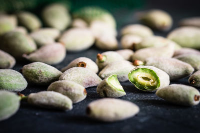 Close-up of green almonds on table