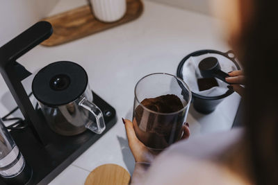 High angle view of person preparing coffee