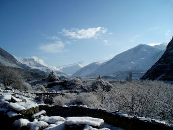 Snow covered landscape against mountain range