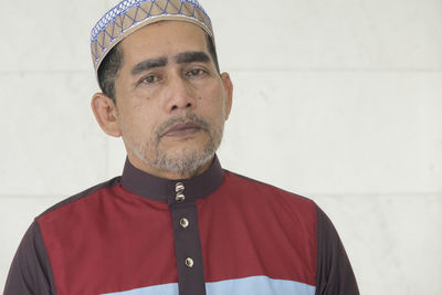 Portrait of man standing in mosque