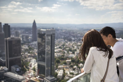 Couple at balcony by city