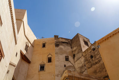 Low angle view of buildings against blue sky