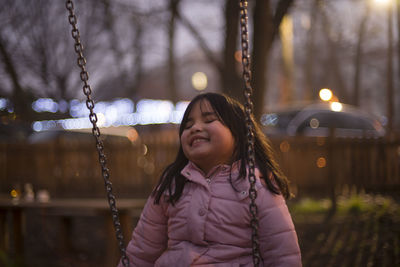 Girl on swing at dusk