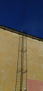 Low angle view of built structure against clear blue sky