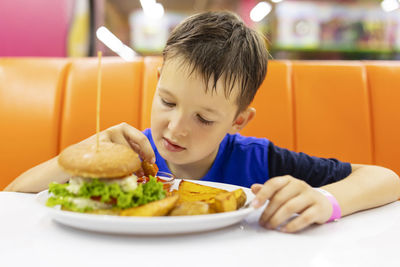 Portrait of boy eating food