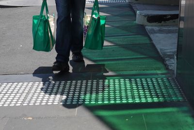 Low section of man walking on sidewalk