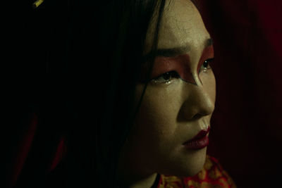 Close-up portrait of young woman looking away