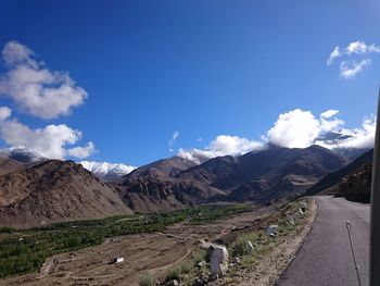 Scenic view of mountains against blue sky