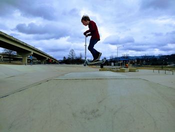 Full length of man skateboarding on skateboard against sky