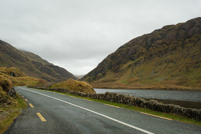 Road amidst mountains against sky