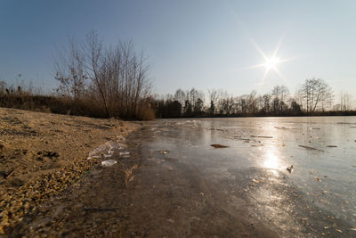 Scenic view of frozen lake against clear sky during winter