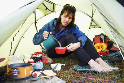 Woman preparing food in tent