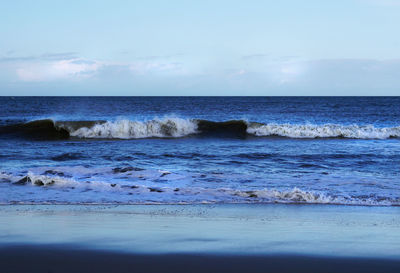 Scenic view of sea against cloudy sky