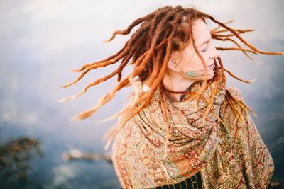 Close-up of woman standing against sky