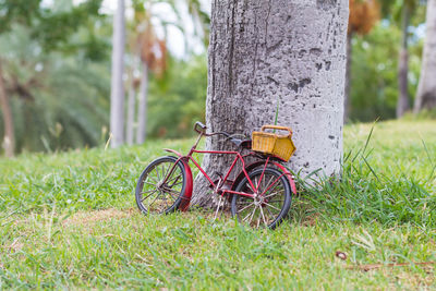 Bicycle by tree on field