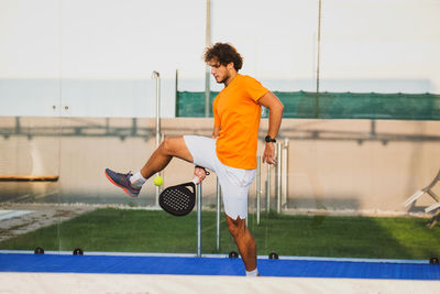Side view of man playing with ball on field
