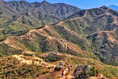 People on landscape against mountains