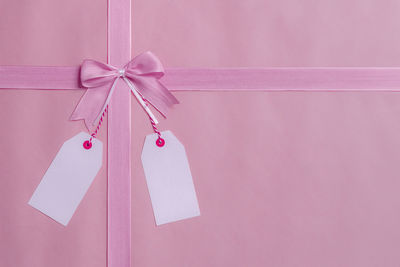 Close-up of pink ribbon tied on gift box