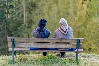 Woman sitting on bench in park