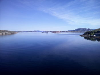 Scenic view of lake against blue sky