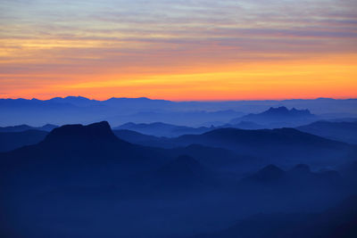 Scenic view of silhouette mountains against sky during sunset