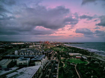 High angle view of townscape by sea against sky