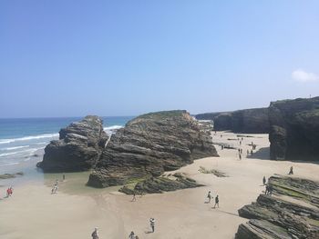 Scenic view of beach against clear blue sky