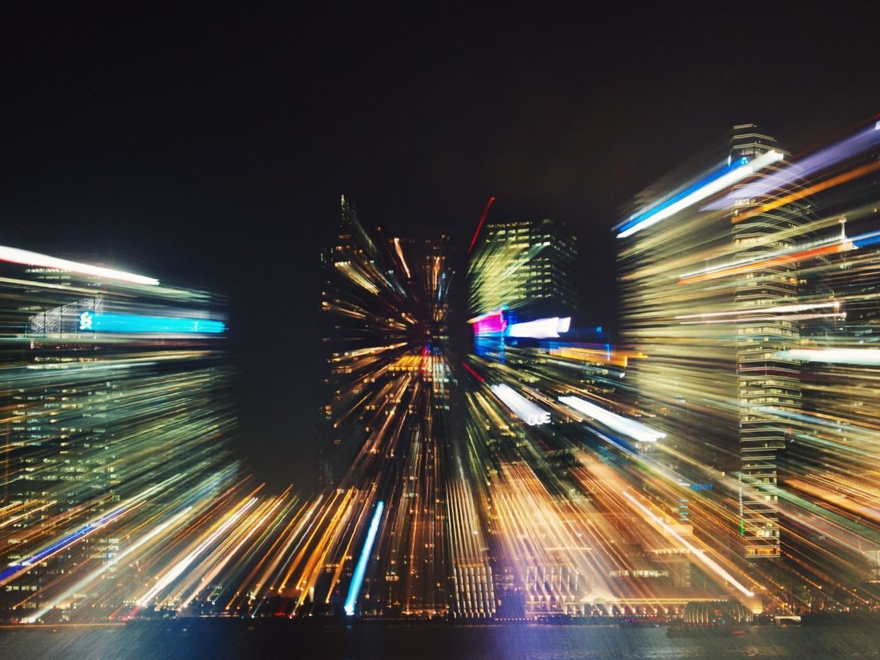 illuminated, night, long exposure, motion, blurred motion, light trail, speed, architecture, city, built structure, building exterior, multi colored, glowing, arts culture and entertainment, transportation, ferris wheel, sky, low angle view, city life, outdoors