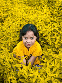 Portrait of cute girl with yellow flowers