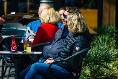 Rear view of couple sitting at restaurant