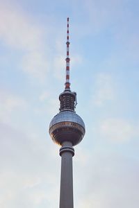 Low angle view of fernsehturm tower against cloudy sky