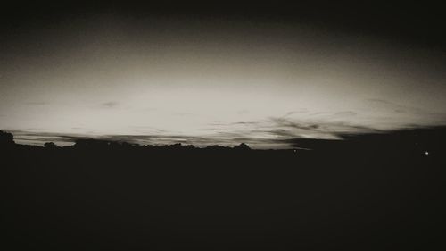 Silhouette landscape against sky during sunset