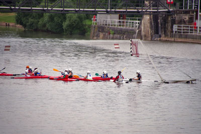 High angle view of people rowing in river
